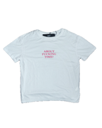 White t-shirt with pink text on a white background